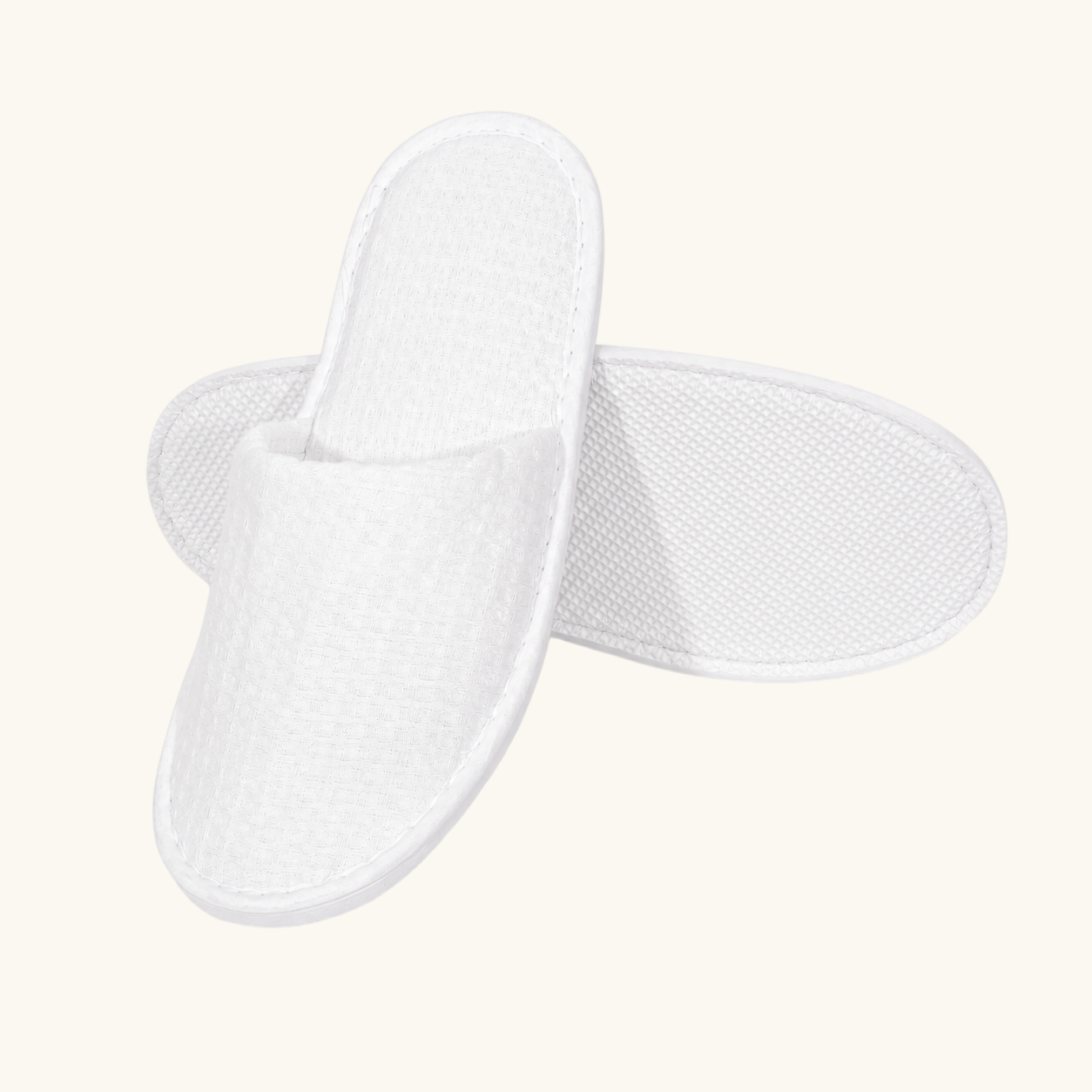 White waffle-weave custom hotel slipper, front view, ready for embroidered logo